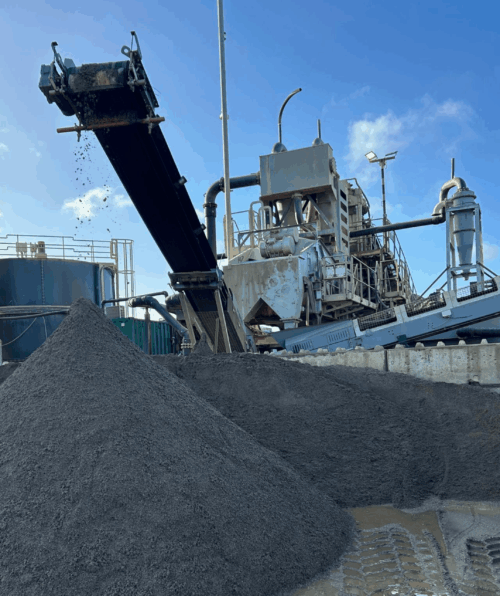 Aggregates with Blue SKies Aggregates falling off a conveyor belt with blue skies